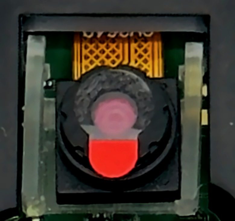 Hopper camera lens with the red protective sticker still on it